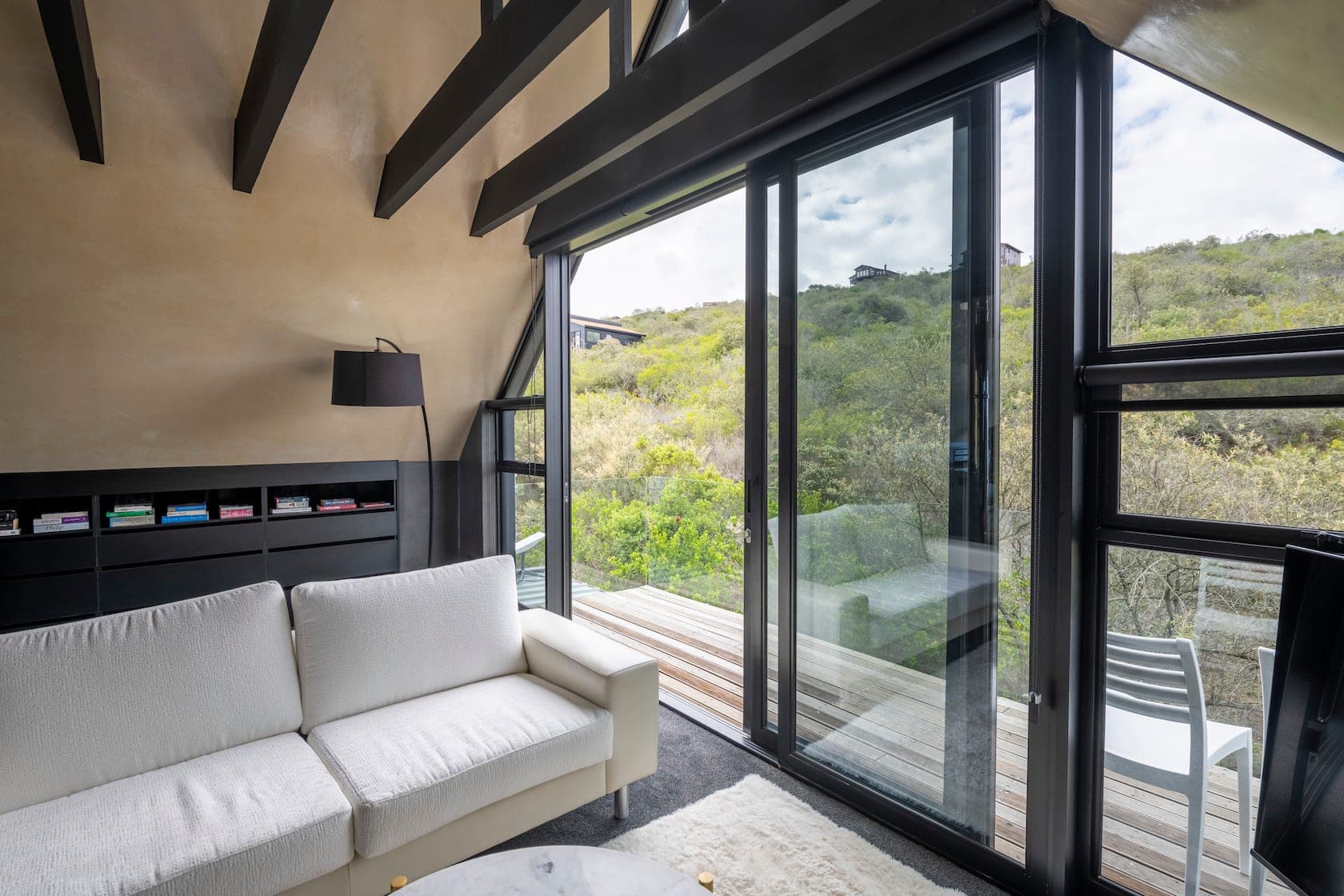 Cosy sitting nook with sofa and sliding deck doors
