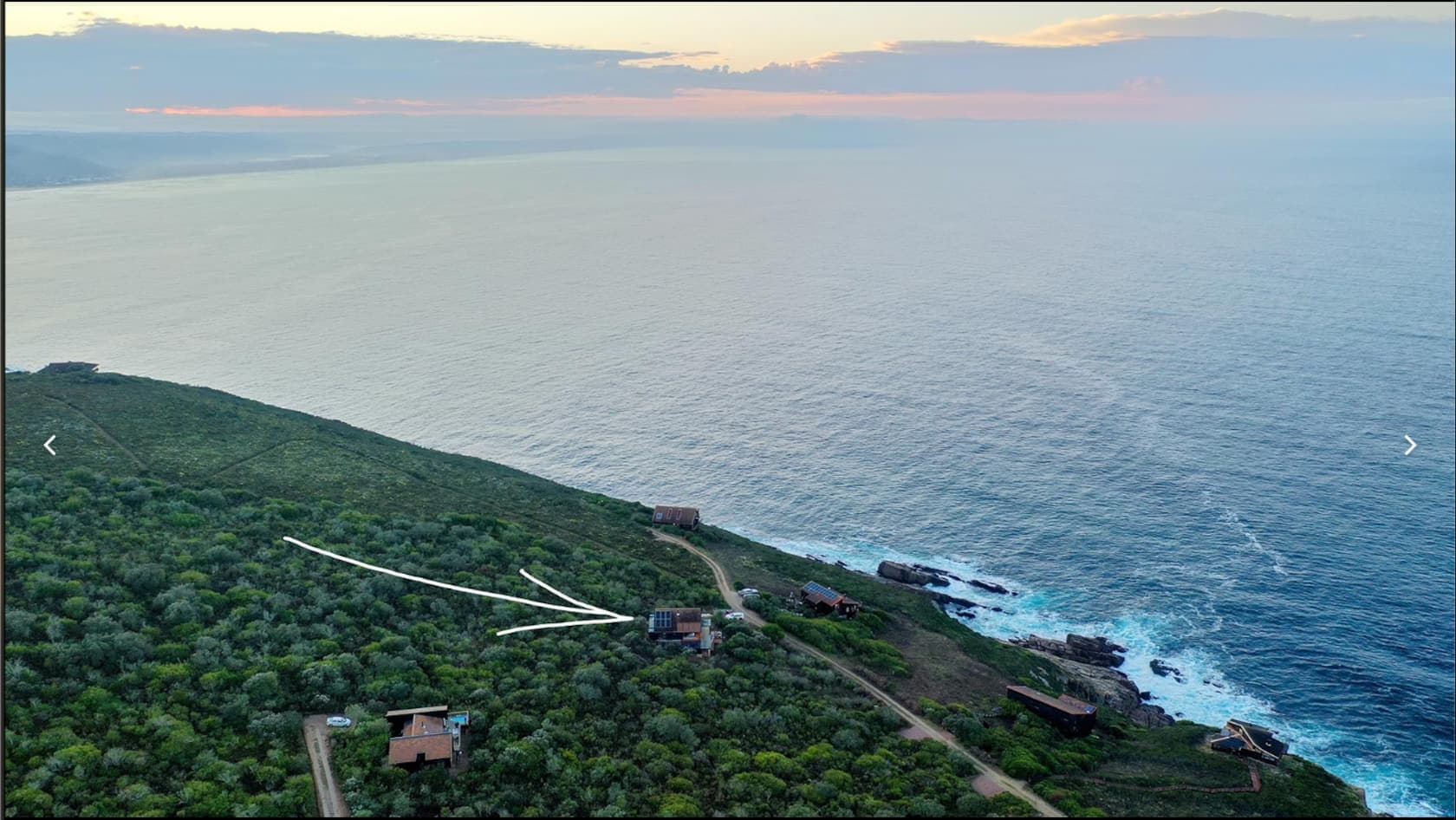 A secluded home perched above the ocean within a private reserve